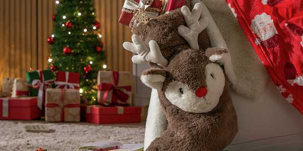 A stuffed reindeer Christmas stocking filled with gifts.